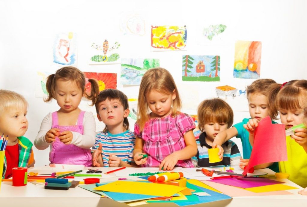 Large group of kids of little boys and girls  on the art lesson class